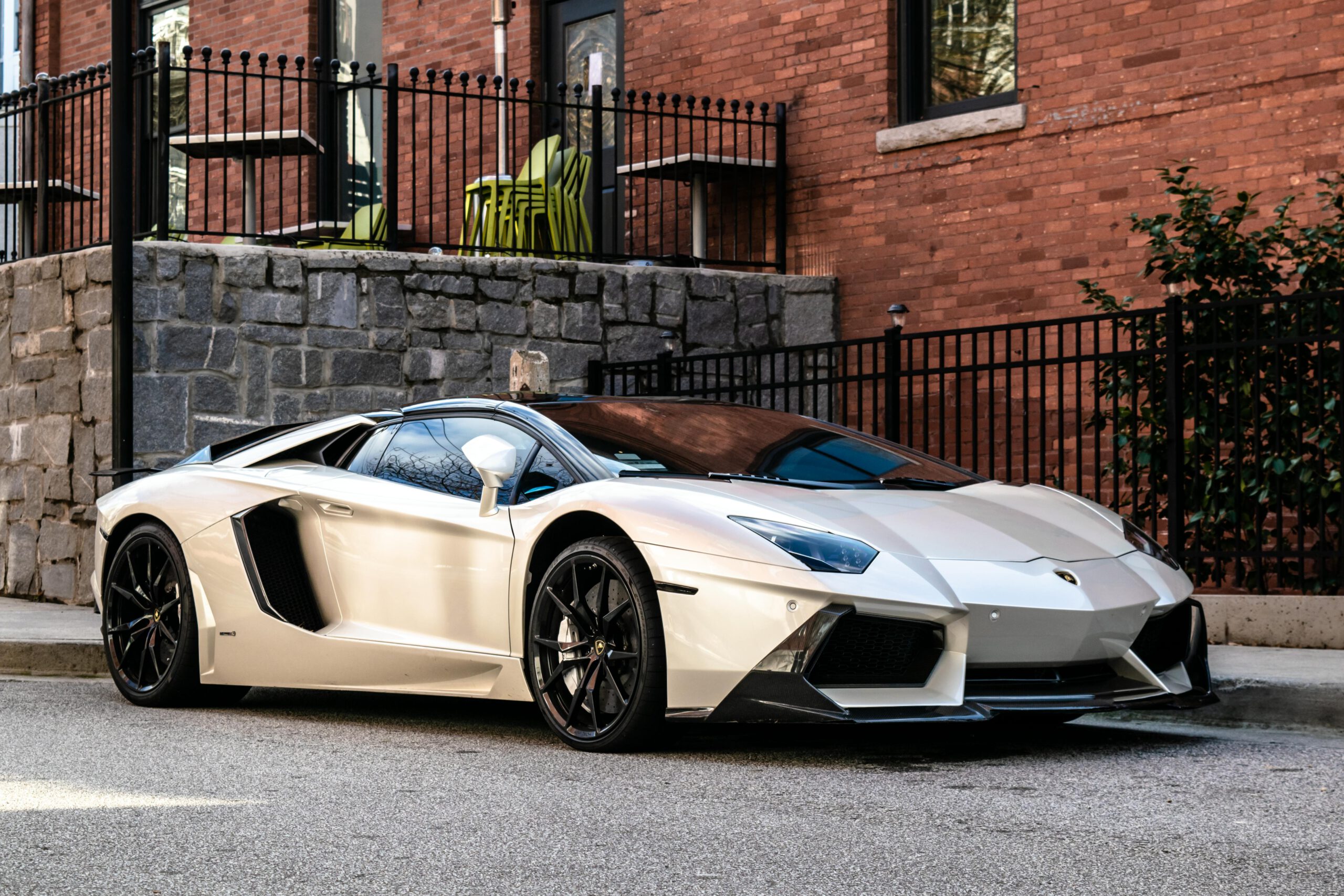 Elegant white sports car parked on a city street in Atlanta, showcasing luxury design.